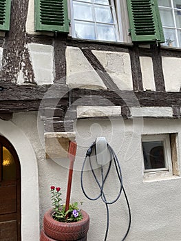 Ancient Fachwerk house with electric vehicle charging station in Tubingen city