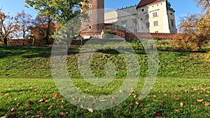 The ancient and famous Wawel Castle in the center of Krakow, and the lawn in front of it. Against a