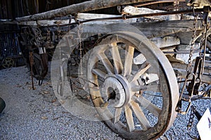 A ancient farm cart showing wheels and framework