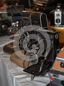 Ancient Folding Cameras with Bellows on their Leather Cases