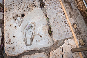 Ancient footprint, female figure and heart shape on the marble ground. Ephesus Ancient City
