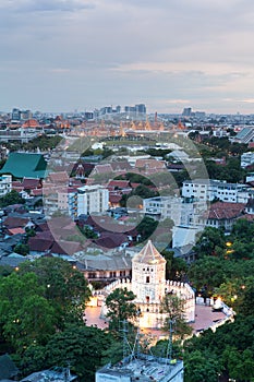 Ancient fortress tower with Grand Palace at Dusk