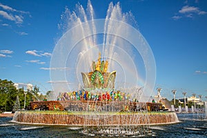 An ancient fountain in the form of a mountain of gems of red green yellow blue with a rainbow