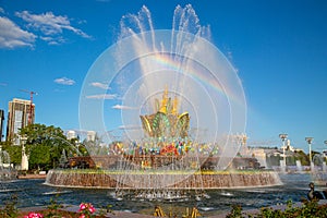 An ancient fountain in the form of a mountain of gems of red green yellow blue with a rainbow