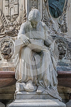 Ancient fountain statue of sensual Italian Renaissance Era woman reading a big book, Magdeburg, Germany