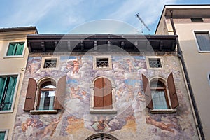 An ancient fresco on the wall of the house. Conegliano. Italy.