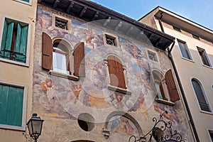 An ancient fresco on the wall of the house. Conegliano. Italy.