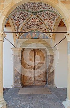 Ancient frescoed porch of a medieval church in the Dolomites, Italy photo
