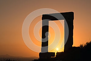 Ancient gate of Apollon temple at sunset on Naxos island photo