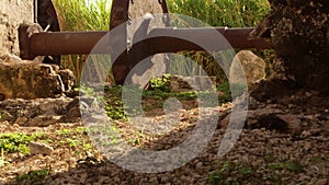 Ancient gear wheel sitting next to 18th century aqueduct Montego Bay, Jamaica