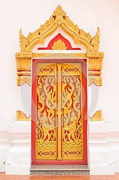 Ancient Gold carving wooden door of Thai temple