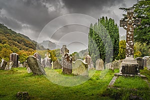 Ancient graves with Celtic crosses in Glendalough Cemetery, Wicklow, Ireland