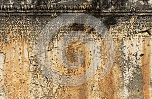 Ancient Greek antique text and inscriptions on the stone wall of the temple. Ancient Greek culture, alphabet and writing