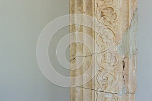 Ancient Greek architecture concept of antique marble column on white wall background texture, copy space