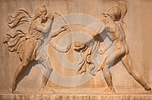 Ancient Greek bas-relief - Amazon with full military equipment fighting a Greek warrior. Athens, Greece