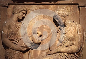 Ancient Greek bas-relief on grave stele, marble sculpture of women and child