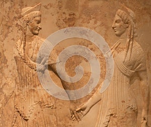 Ancient Greek bas-relief with two female figures, Nymphs or Graces holding hands and dancing