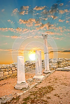 Ancient Greek columns at sunset