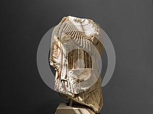 Ancient greek female statue against on gray background