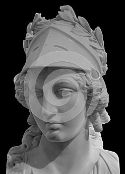 Ancient Greek goddess Athena Pallas statue isolated on black. Marble woman head in helmet sculpture. photo