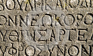 Ancient Greek text inscriptions on a stone wall