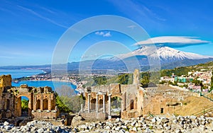 Ancient Greek theatre in Taormina on background of Etna Volcano, Italy photo