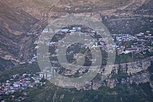 Ancient Gunib settlement on the mountain slopes at sunset