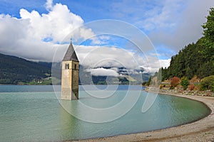 Ancient half-submerged bell tower in Graun im Vinschgau