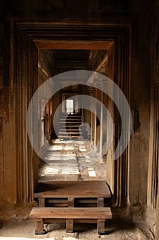 Ancient hallway and stone doorways inside Angkor Wat in Cambodia