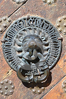 Ancient handle of door with metal lion head.
