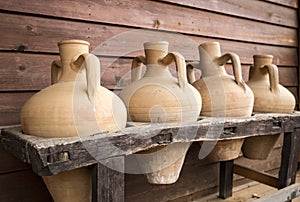 Ancient handmade clay jugs for beverage storage photo
