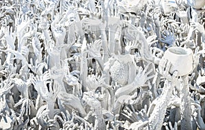 Ancient hands scuplture at White Temple in Chiang Rai Thailand