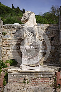 Ancient headless statue on a pedestal