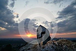 Ancient helmet, cloudy sunset on background.