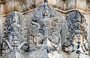 Ancient Hindu-Khmer Style Stucco Ruins of Garuda and Hindu Gods on the Central Prang of Wat Si Sawai in The Sukhothai Historical P photo