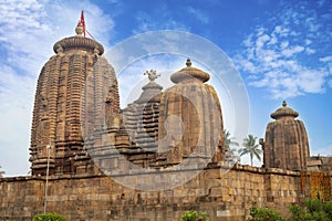 Ancient Hindu Temple Brahmesvara Temple. Ornately carved building with multiple towers inside a walled compound.