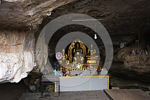 Ancient holy buddha statue in antique mystery cave for thai people traveler travel visit respect praying blessing wish of Wat Huai