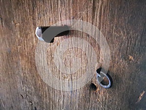 Ancient hook on old wooden door photo