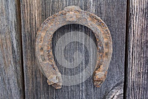Ancient horseshoe on a old wooden background
