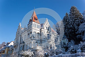 Ancient house at the beginning of a snowy winter in December