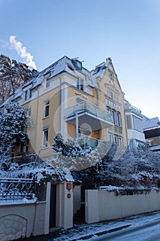 Ancient house at the beginning of a snowy winter in December