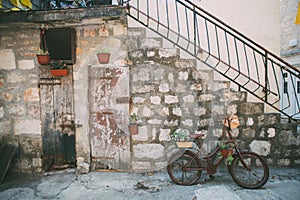 Ancient house facade decorated with bike