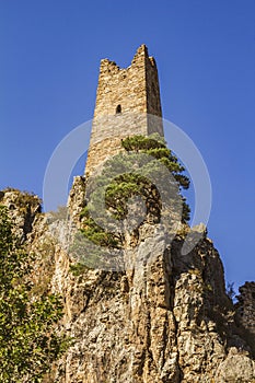 An ancient impregnable stone castle built on the pinnacles of steep rocky cliffs.