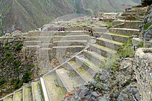 Ancient Inca archaeological terraces with lots of tourists photo