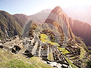 Ancient Inca City of Machu Picchu illuminated by sun. Ruins of Incan Lost city in Peruvian jungle. UNESCO World Heritage