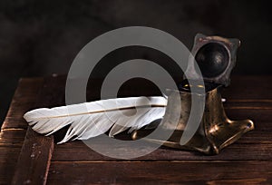 Ancient Inkwell and feather pen