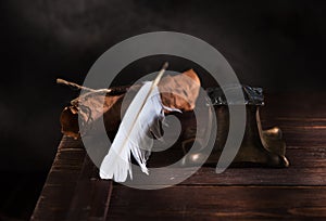 Ancient Inkwell, feather pen and old paper with a seal