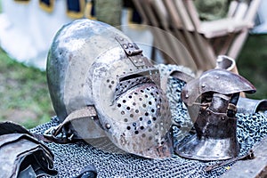 Ancient Iron Knight Helmet and Metal Glove on Desk - Middle Ages Armor Concept