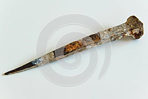 An ancient iron nail on white background