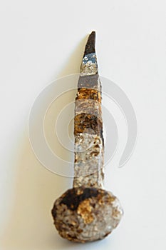 An ancient iron nail on white background